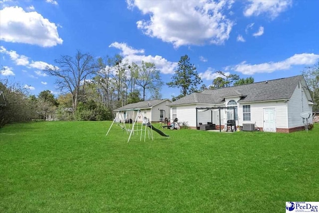 813 Williams St, Lake City, SC 29560 - rear view of property with a shingled roof, a lawn, and cooling unit