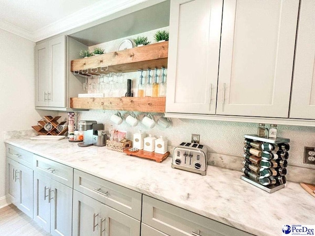 bar featuring ornamental molding and backsplash