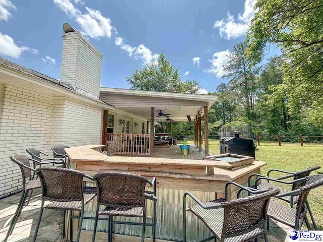 view of patio / terrace featuring a deck and a ceiling fan