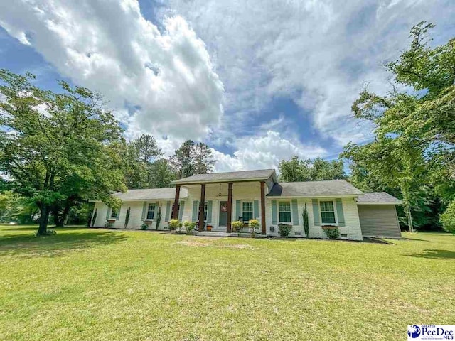 ranch-style home featuring a front yard and covered porch