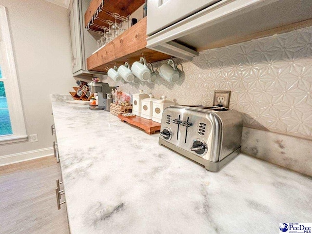 detailed view of baseboards and light countertops