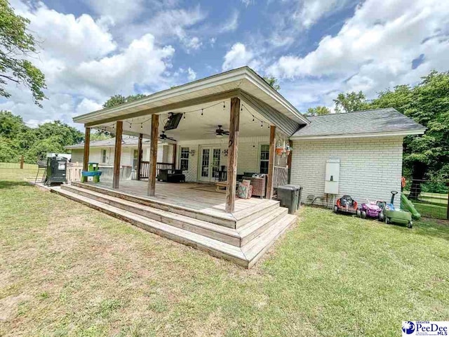 back of property with french doors, ceiling fan, brick siding, and a deck