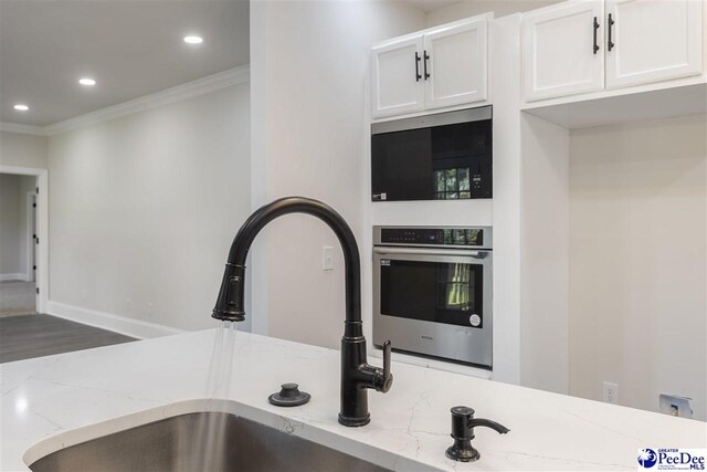 400 Millstone Rd, Florence, SC 29505 - kitchen with oven, crown molding, a sink, recessed lighting, and light stone counters