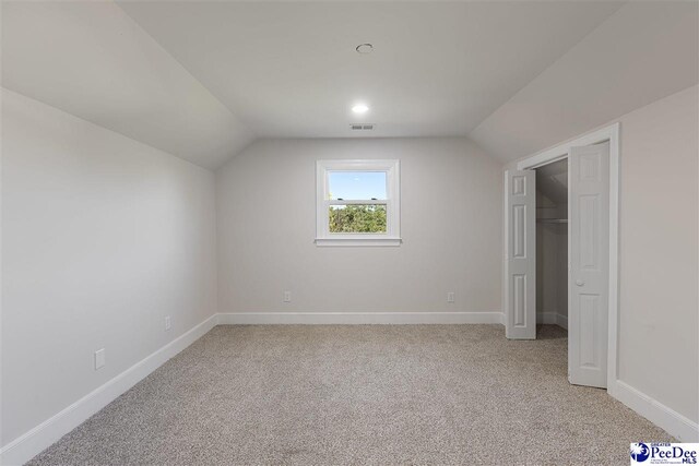 400 Millstone Rd, Florence, SC 29505 - additional living space with vaulted ceiling, light carpet, and baseboards
