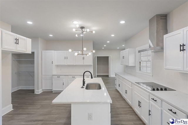400 Millstone Rd, Florence, SC 29505 - kitchen featuring a sink, wall chimney range hood, a chandelier, black electric cooktop, and wood finished floors