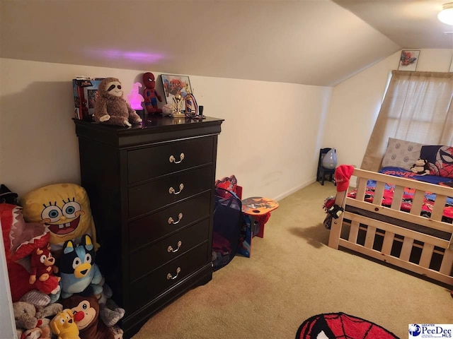 bedroom featuring vaulted ceiling and carpet