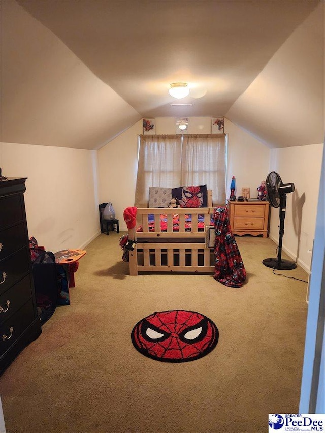 bedroom featuring lofted ceiling and carpet flooring