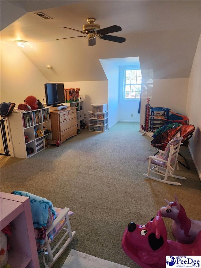 interior space with lofted ceiling, ceiling fan, and carpet