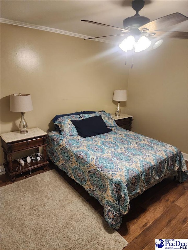 bedroom featuring ornamental molding, dark hardwood / wood-style floors, and ceiling fan