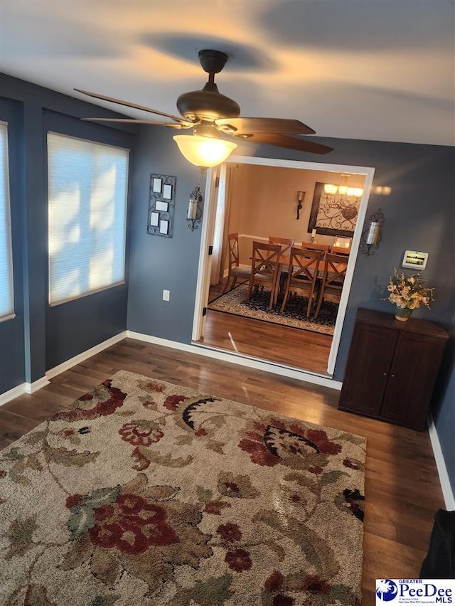 dining area with ceiling fan and dark hardwood / wood-style flooring