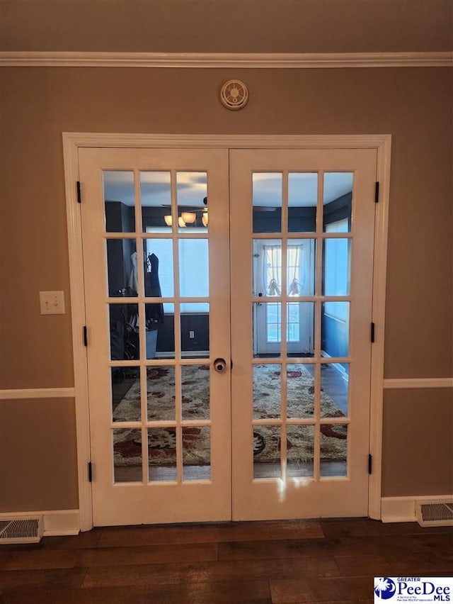 doorway with dark hardwood / wood-style floors and french doors