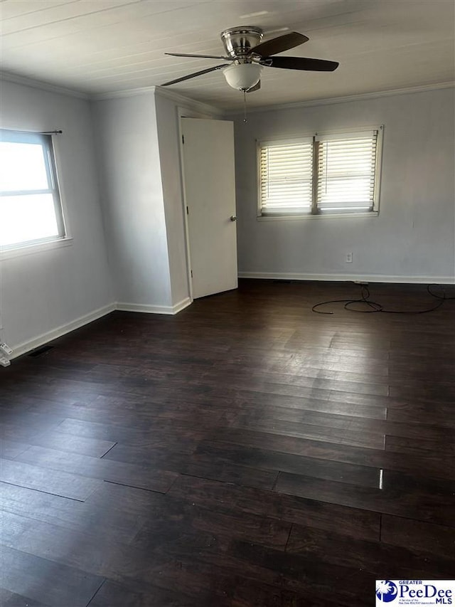 unfurnished room featuring dark wood-style floors, baseboards, ornamental molding, and a ceiling fan