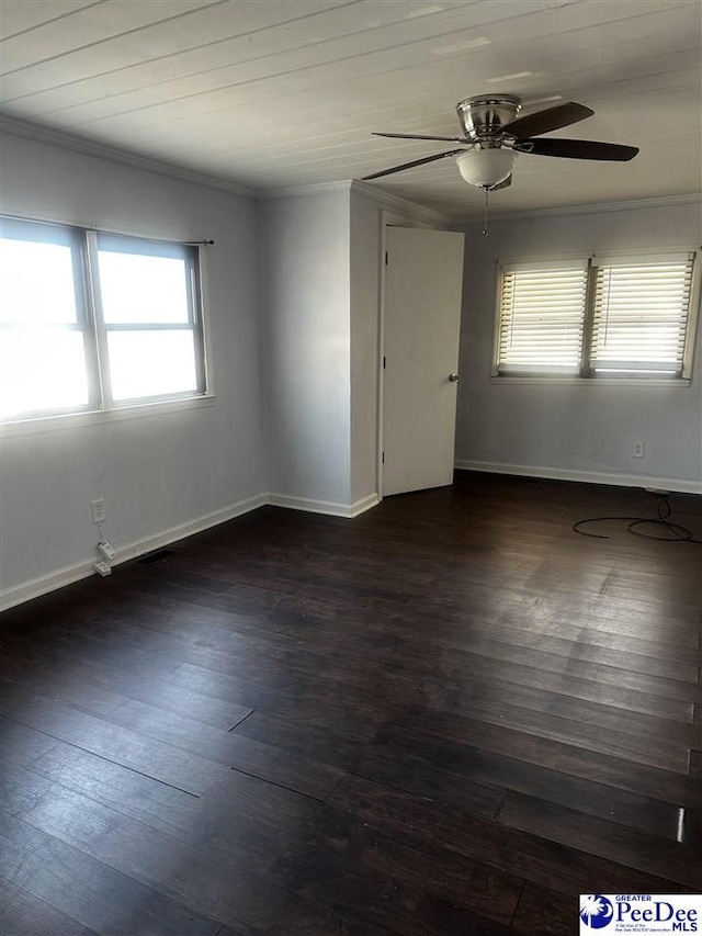 empty room with dark wood-style floors, a ceiling fan, baseboards, and crown molding