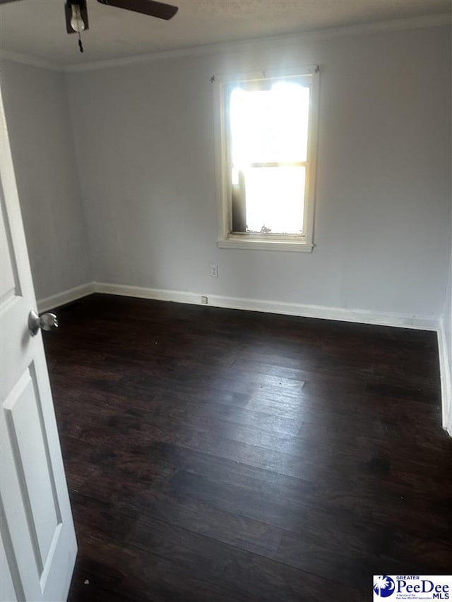 unfurnished room featuring ceiling fan, baseboards, ornamental molding, and dark wood finished floors