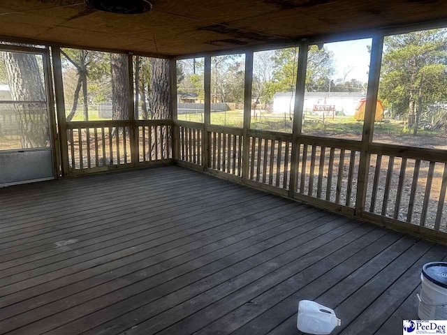 unfurnished sunroom with a water view