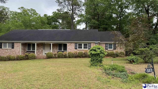 ranch-style home with brick siding, a porch, and a front lawn