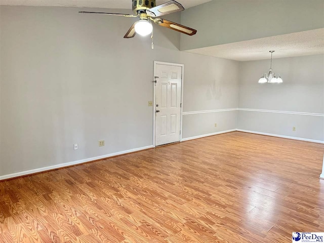 1215-G Brittany Dr, Florence, SC 29501 - spare room with a ceiling fan, a chandelier, light wood-type flooring, baseboards, and a textured ceiling