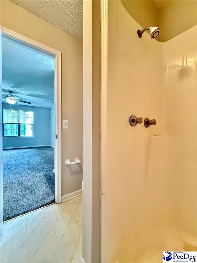 1215-G Brittany Dr, Florence, SC 29501 - full bath featuring a textured ceiling, a shower, baseboards, and a ceiling fan
