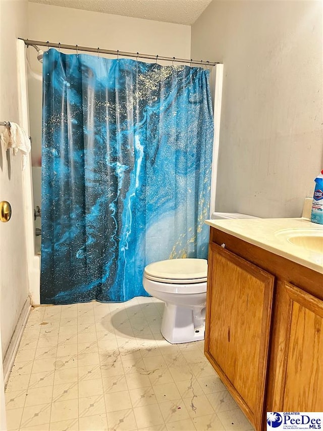 full bath featuring a textured ceiling, toilet, tile patterned floors, and vanity