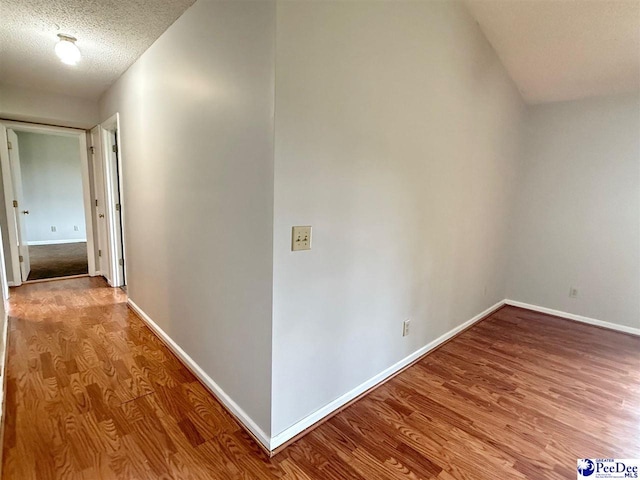 1215-G Brittany Dr, Florence, SC 29501 - corridor with wood finished floors, baseboards, and a textured ceiling