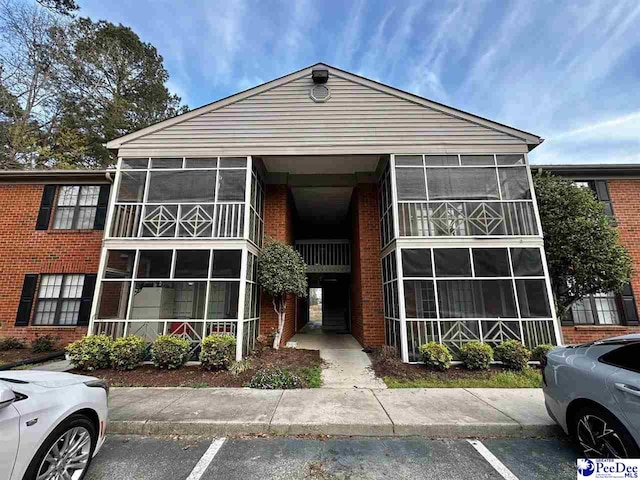 view of building exterior with uncovered parking