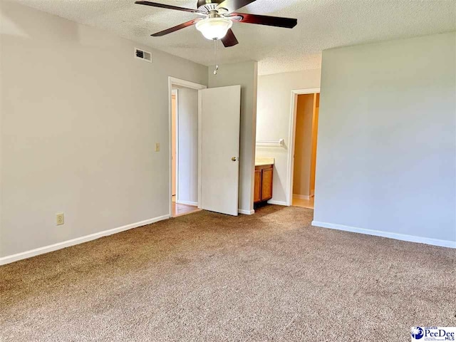 1215-G Brittany Dr, Florence, SC 29501 - unfurnished bedroom featuring a textured ceiling, carpet floors, baseboards, and a ceiling fan