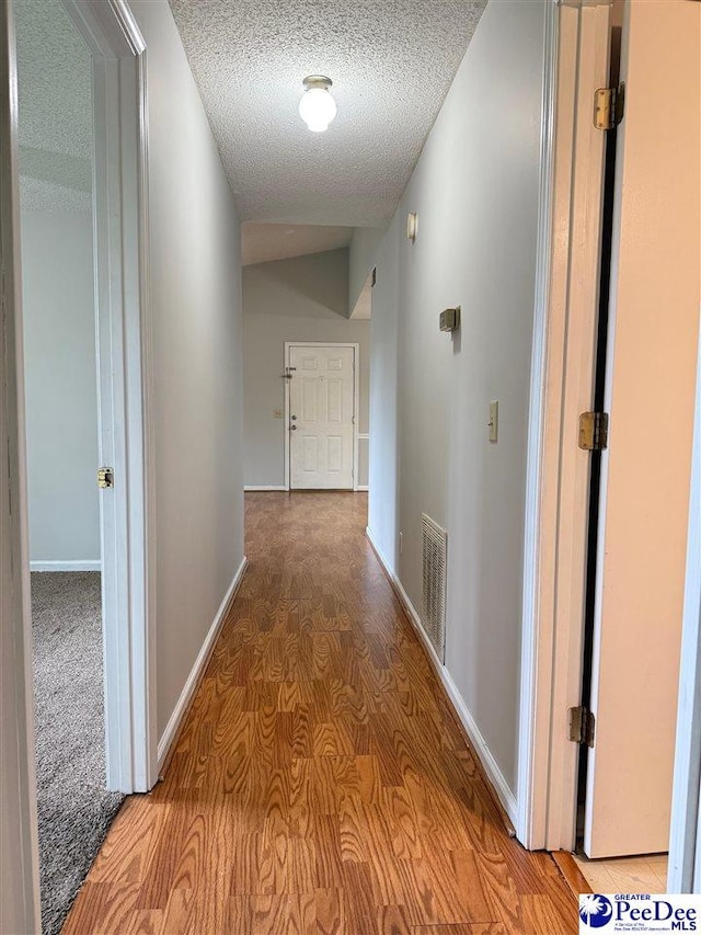1215-G Brittany Dr, Florence, SC 29501 - corridor with a textured ceiling, wood finished floors, and baseboards