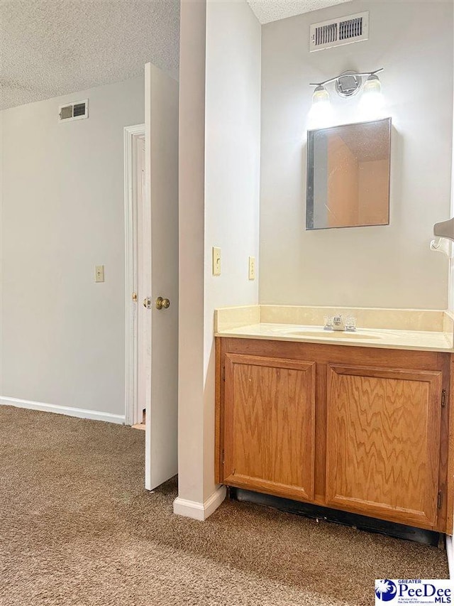 1215-G Brittany Dr, Florence, SC 29501 - bathroom with a textured ceiling, vanity, and baseboards
