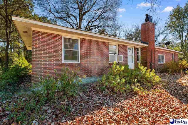 ranch-style home featuring cooling unit