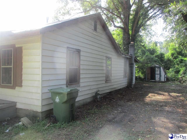 view of property exterior with a shed