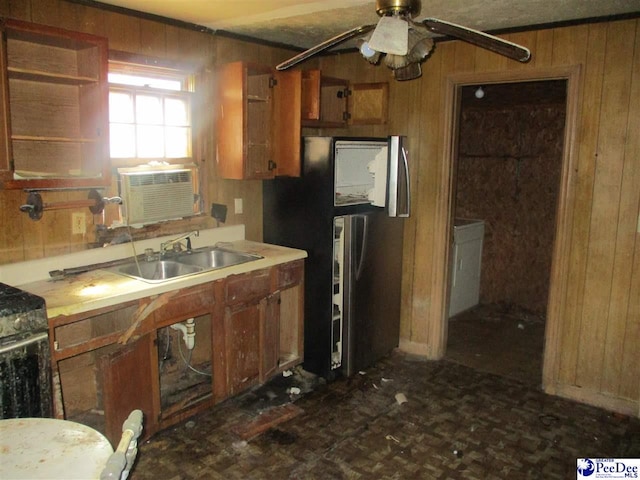 kitchen featuring sink, stainless steel fridge, wooden walls, cooling unit, and ceiling fan