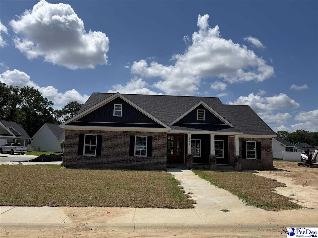 2902 Fincher Dr, Florence, SC 29051 - craftsman-style home with brick siding, covered porch, and a front lawn