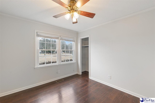 spare room with dark wood-type flooring, ceiling fan, crown molding, and a textured ceiling