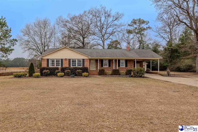 ranch-style home with a carport and a front lawn