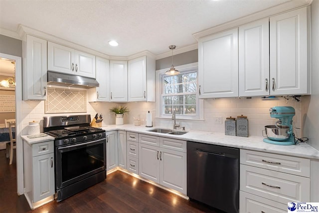 kitchen with pendant lighting, white cabinetry, sink, black dishwasher, and gas stove