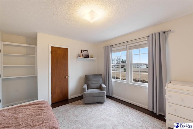 sitting room featuring a textured ceiling and light wood-type flooring