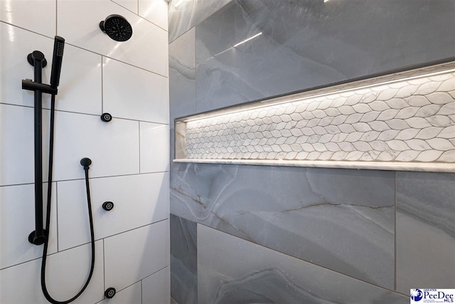 bathroom featuring a shower and tile walls