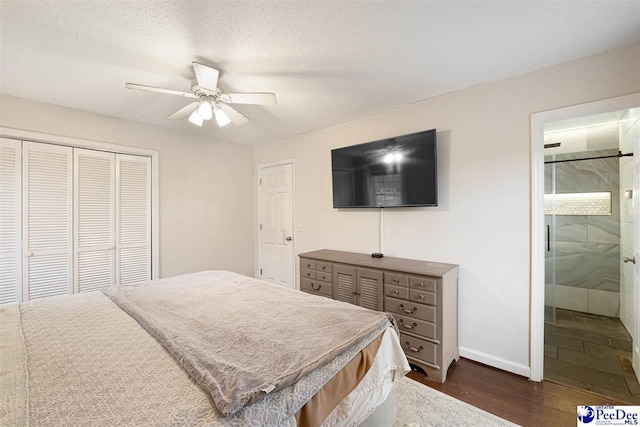 bedroom featuring dark hardwood / wood-style floors, ensuite bath, ceiling fan, a textured ceiling, and a closet