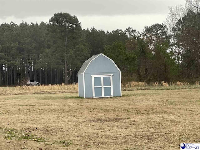 view of shed with a forest view