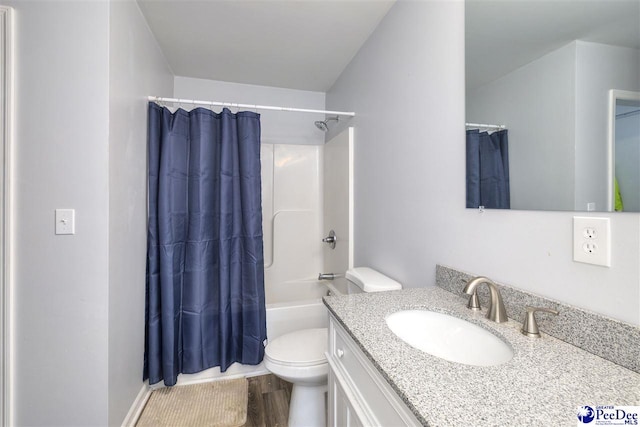 full bathroom featuring vanity, toilet, wood finished floors, and shower / bath combo