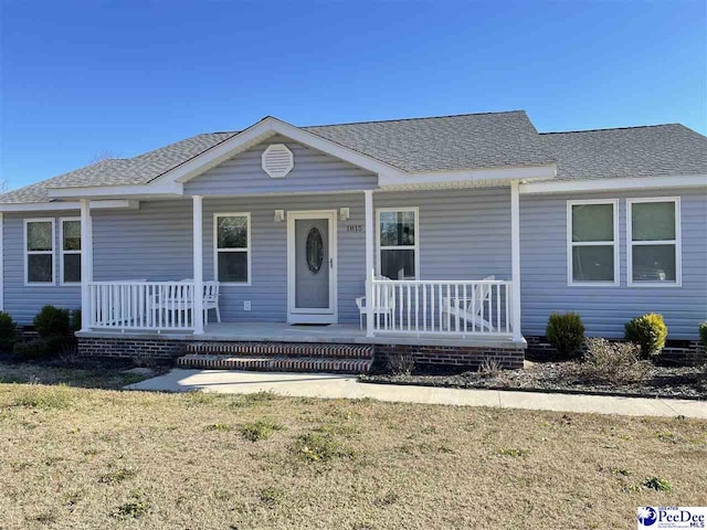 view of front of home featuring covered porch and roof with shingles