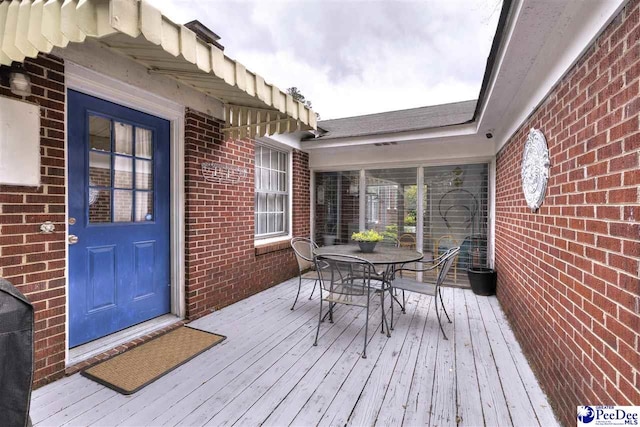 wooden deck featuring outdoor dining space
