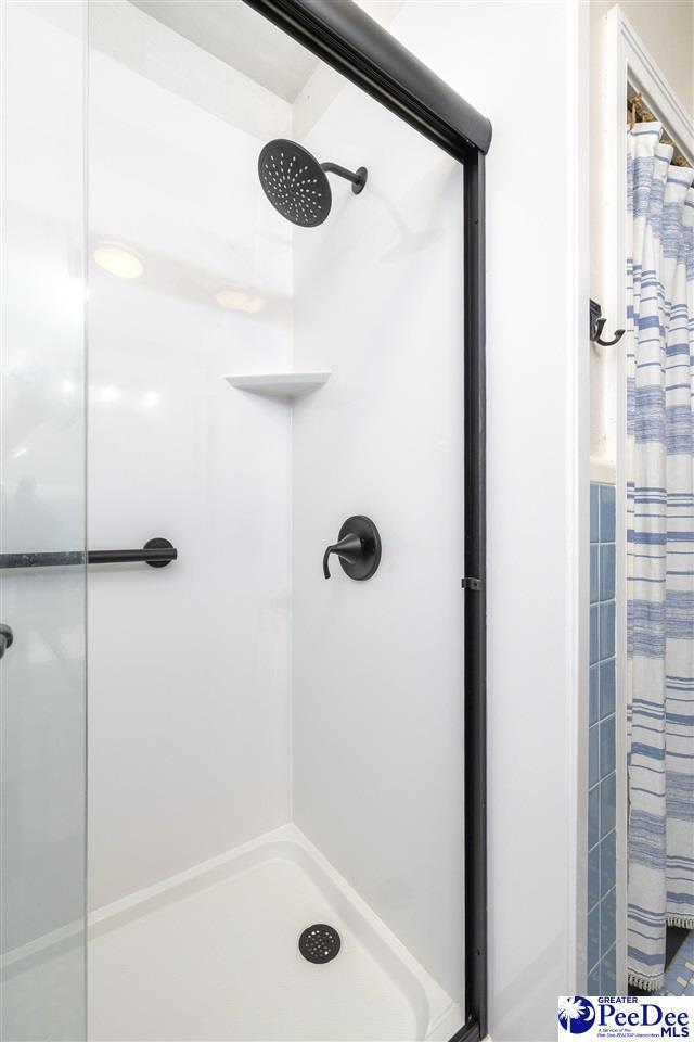 full bathroom with a shower stall