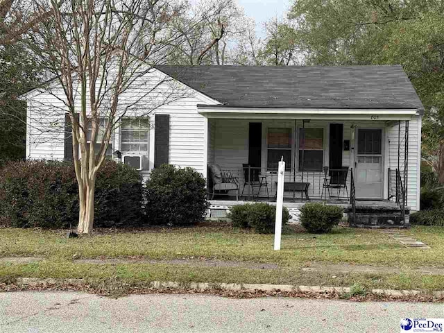 view of front of property with covered porch and a front yard