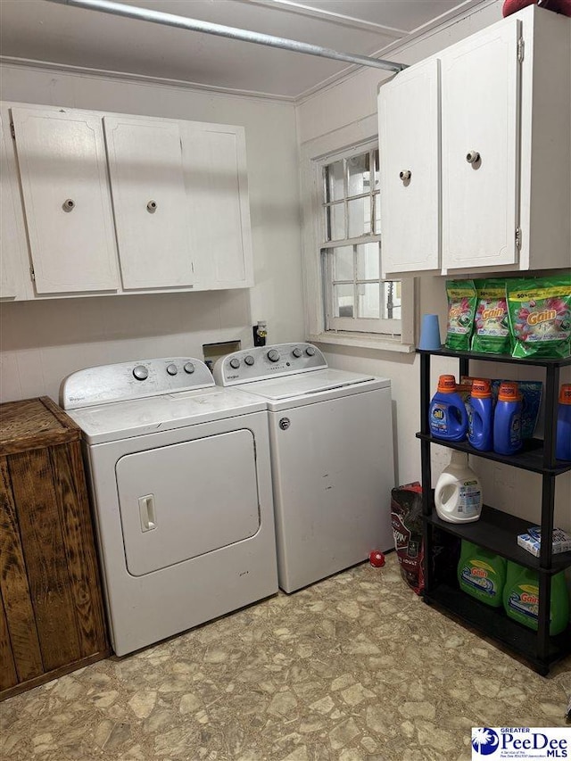 laundry area featuring washer and dryer and cabinets