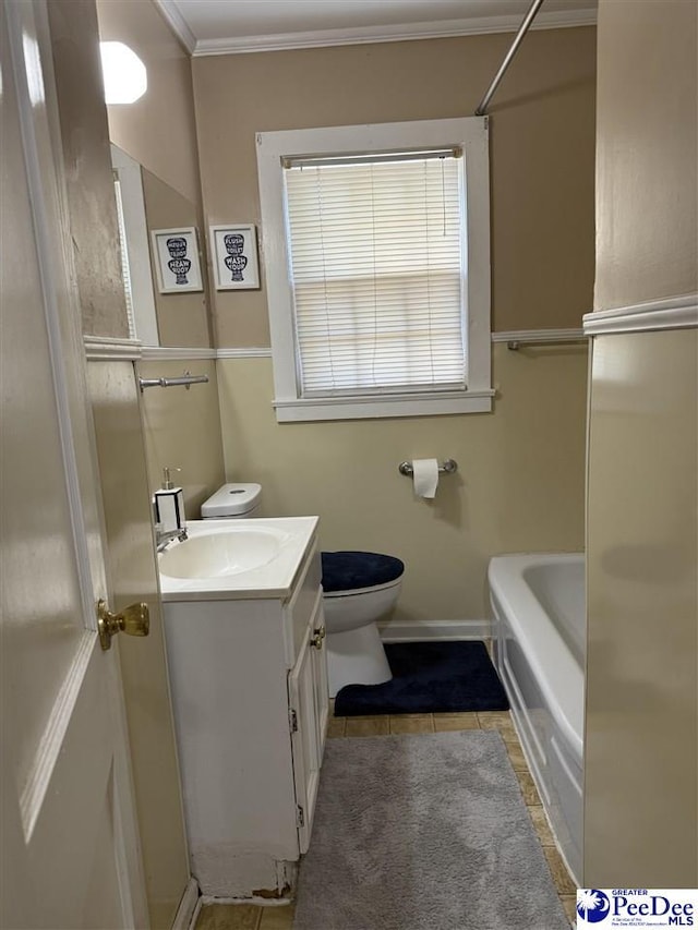 bathroom with tile patterned flooring, a bathtub, vanity, ornamental molding, and toilet