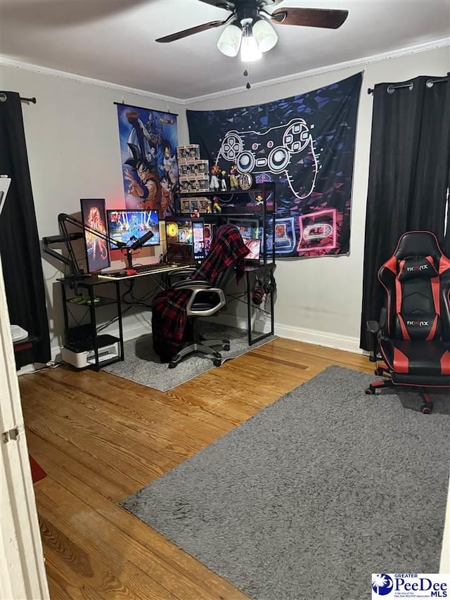 office space featuring wood-type flooring, crown molding, and ceiling fan