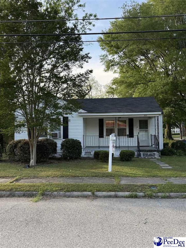 view of front of property featuring covered porch and a front yard