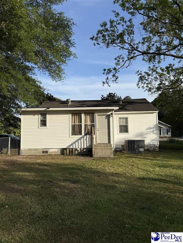 view of front of house with central AC, entry steps, a front lawn, and crawl space