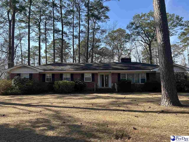 ranch-style house with brick siding and a front lawn